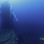 Scuba divers congregate around island on ship wreck USS Saratoga, Bikini Atoll, Marshall Islands, Micronesia, Pacific