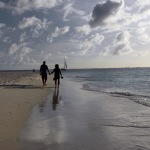 A late afternoon stroll along a serene beach in Aruba