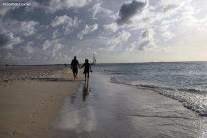 A late afternoon stroll along a serene beach in Aruba